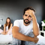 Unhappy couple having arguments and sexual problems in bed