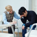 Frustrated young man visiting psychologyst