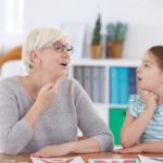 Stuttering girl and speech therapist doing exercises